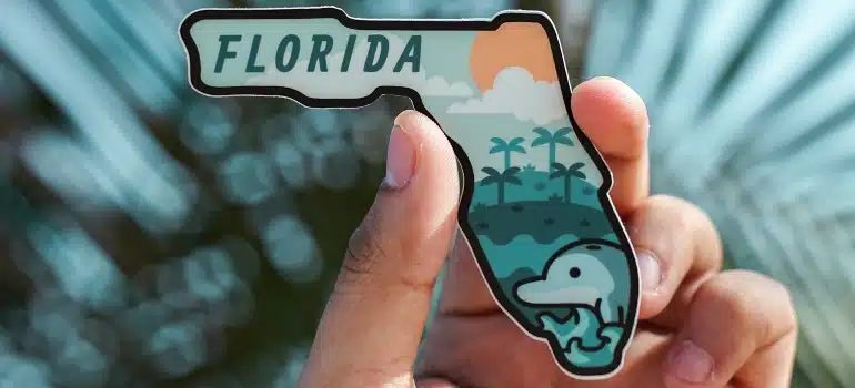 a man holding Florida magnet