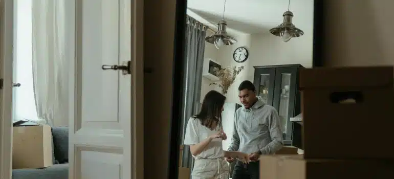 a couple surrounded by boxes