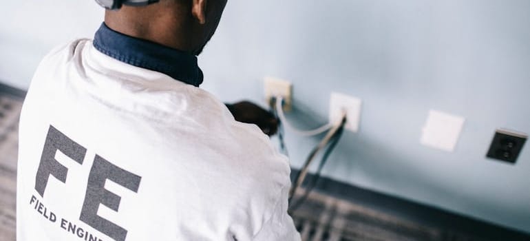 A field engineer is fixing an outlet