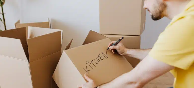a man labeling boxes