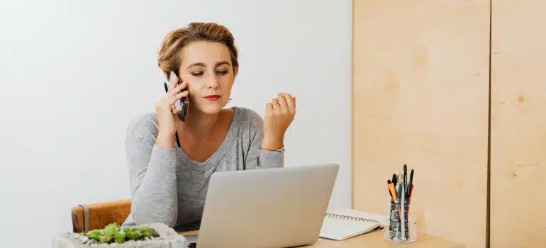 a woman talking on a phone requiring changes to transfer utilities when moving to Fort Lauderdale
