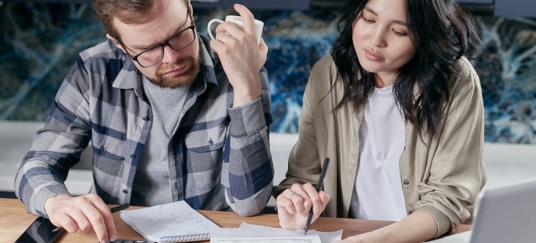 people calculating expenses before moving from Coconut Grove to Fisher Island