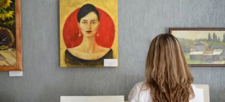a woman in front of pictures on the wall