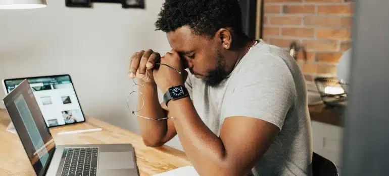 a worried man working on a laptop 
