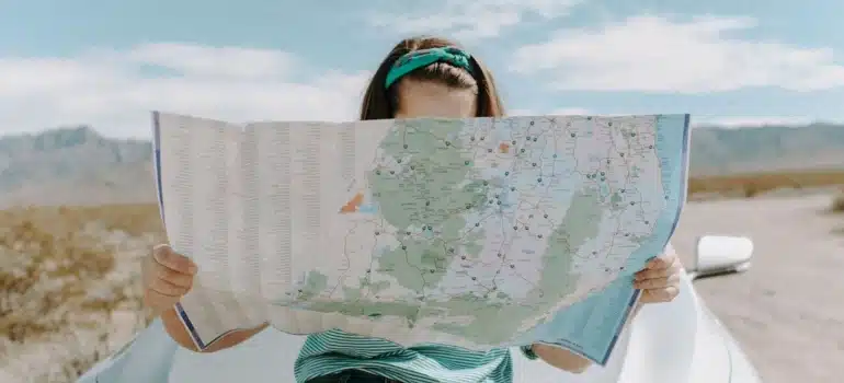 a woman holding a map searching for Most welcoming Miami Dade locations to move to