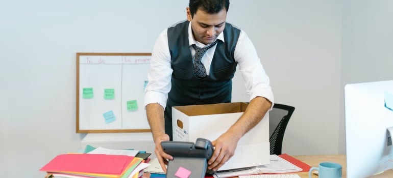 a man packing up office items