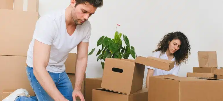 a man packing thinking about how can movers help you stage a home