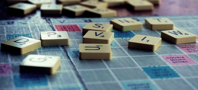 A scrabble board game with little pieces