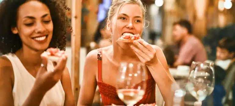 three women eating at one of the best nightlife options in Miami