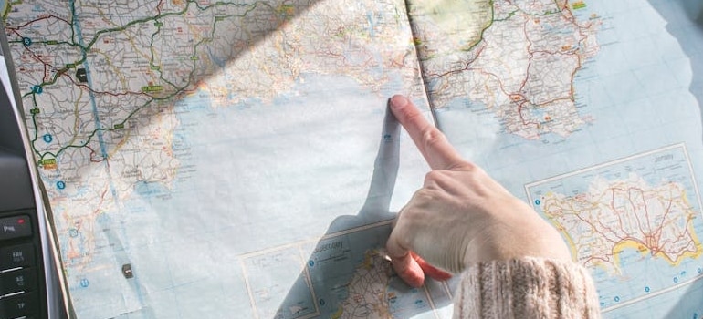 a woman pointing at a map