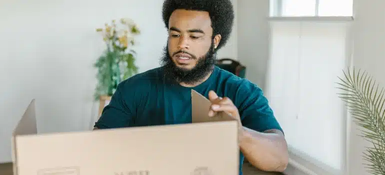 a mover packing a box