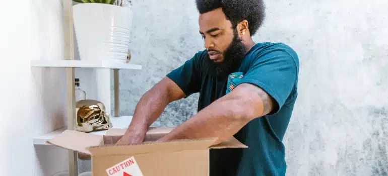 a mover packing a box