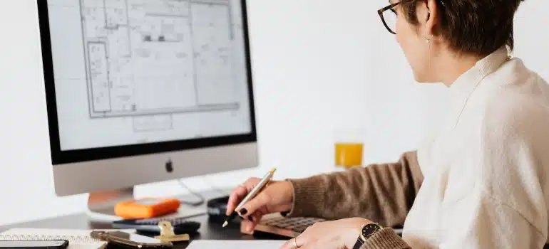 a woman looking at a floor plan for making your Coral Gables home functional 