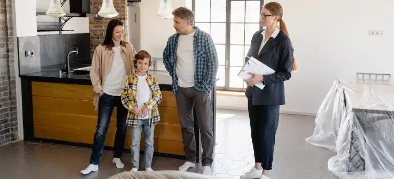 a family with a real estate agent considering The Pros and Cons of Making Pinecrest Your Home and Workplace