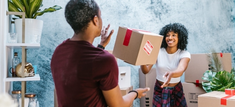 a man and a woman throwing a box