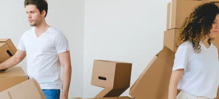 people surrounded by boxes thinking about how to arrange your new home in Sunny Isles Beach after the move