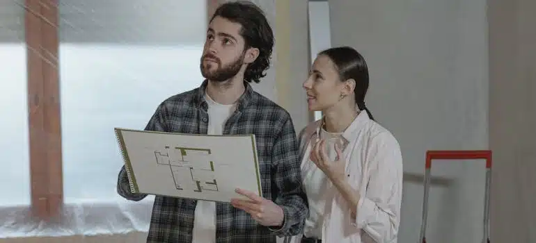 A couple looking at a home under construction