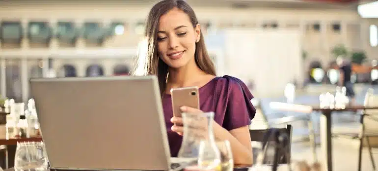 a woman sitting in a cafe searchign for the bets foodie places in Florida.
