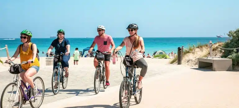 people riding a bike on a beach