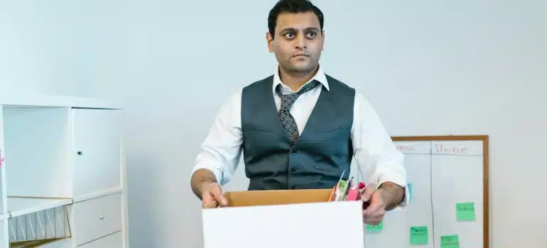 a man packing up office items