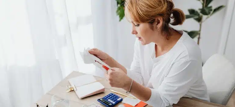 a woman calculating the cost of moving a playroom to South Florida.