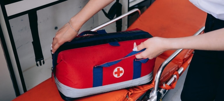 a woman packing first-aid kit when moving a medical center in Florida