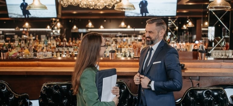 a real estate agent with a cafe manager discussing where to relocate a coffee shop in South Florida