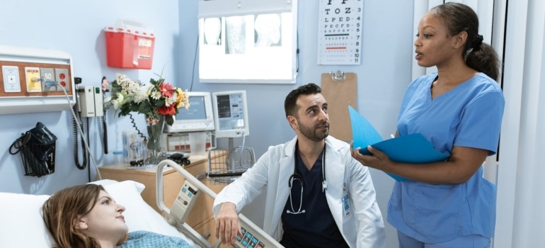 a doctor and a nurse talking with a patient about moving a medical center in Florida