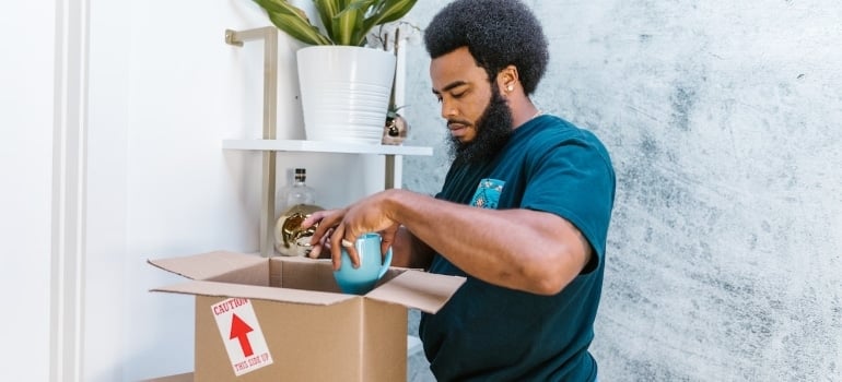 a mover packing a mug