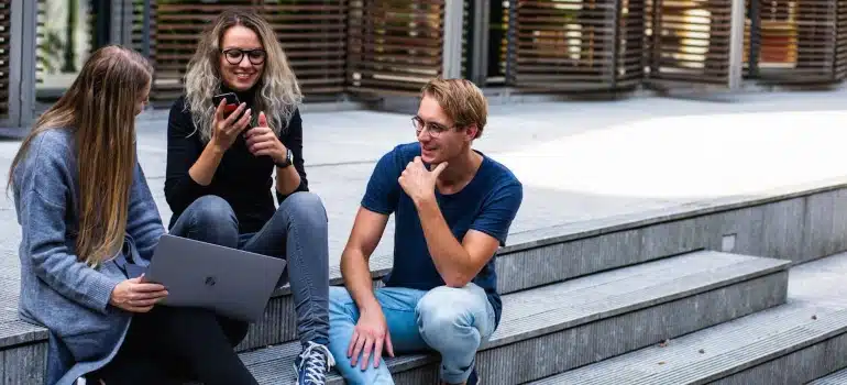 students sitting on stairs laughing