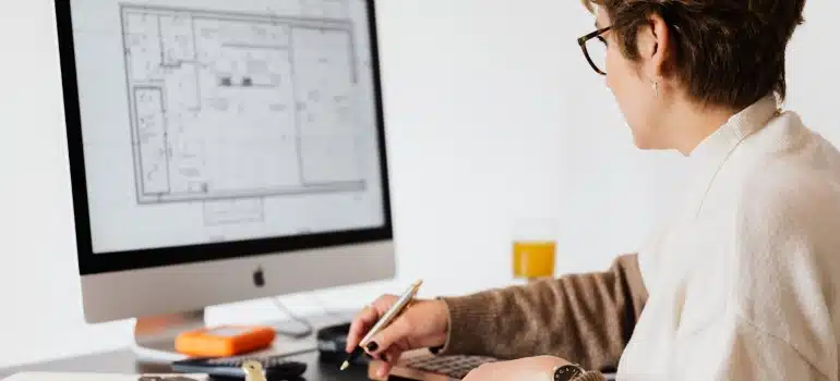 a woman looking at a floor plan about to organize an interstate move