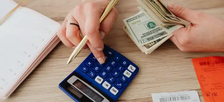 a person calculating to find affordable housing during the move