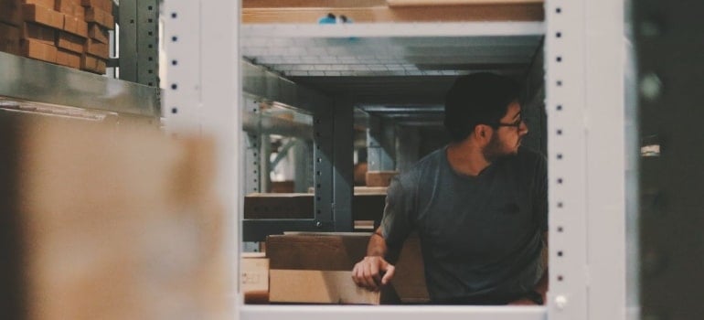 a man in storage thinking about moving offices in the Miami Dade area