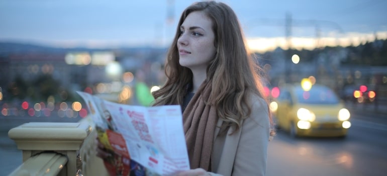 a woman with a map choosing the best location for moving a music store in Hollywood FL