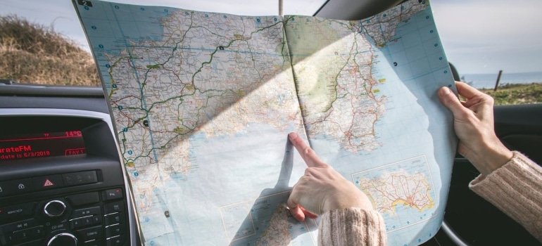 a person pointing at a map searching for the best Florida Cities for moving with pets 