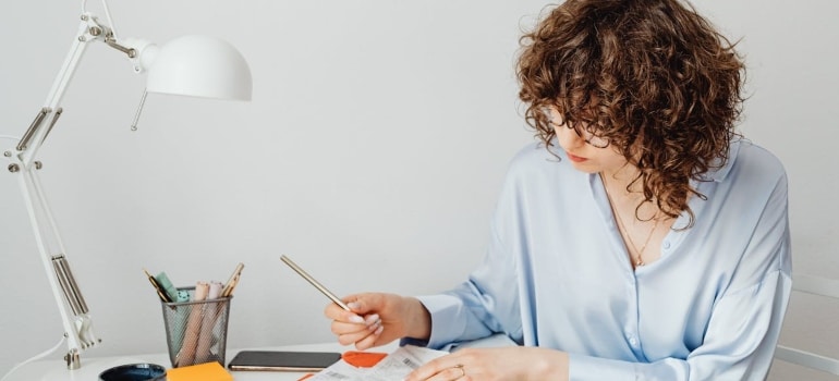 a woman calculating expenses for moving a music store in Hollywood FL