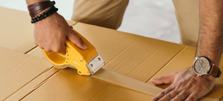 a man taping a box