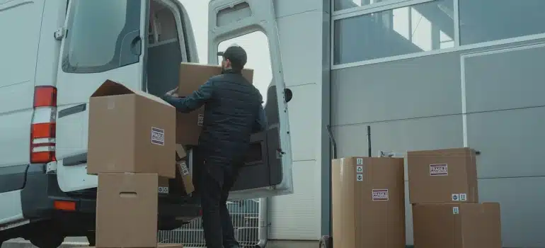 a mover packing boxes into a moving van