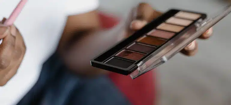 a woman holding a makeup palette