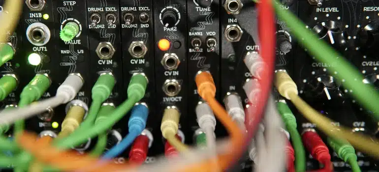 A close up of numerous colorful cables in audio equipment.