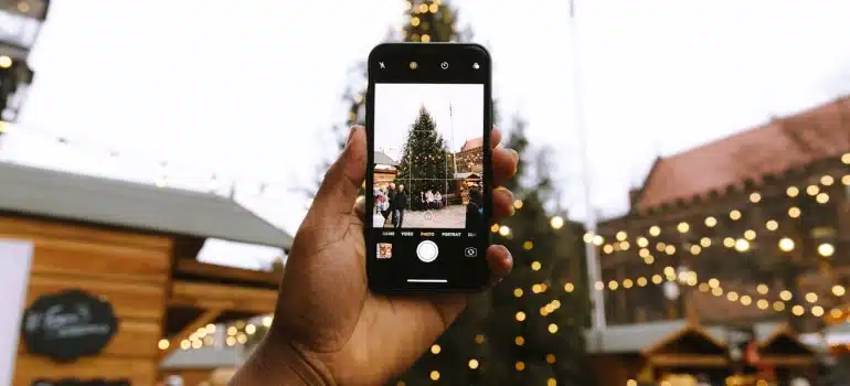 a person taking photo of one of the best South Florida Christmas Markets