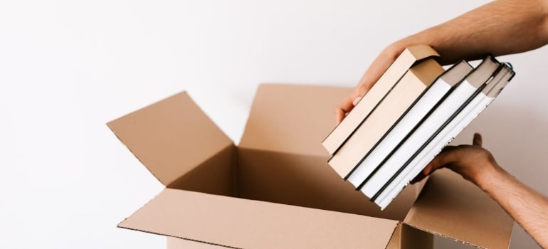 a woman packing boxes to make some extra money by decluttering before moving