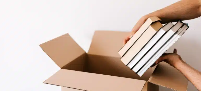a woman packing boxes to make some extra money by decluttering before moving