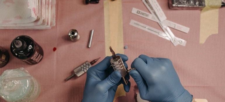 a person holding a tattoo machine