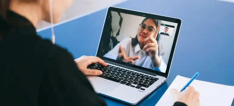 a person having an online meeting in order to buy a house in South Florida remotely