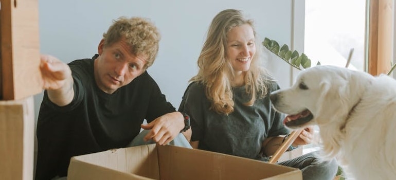 A couple packing with a pet dog