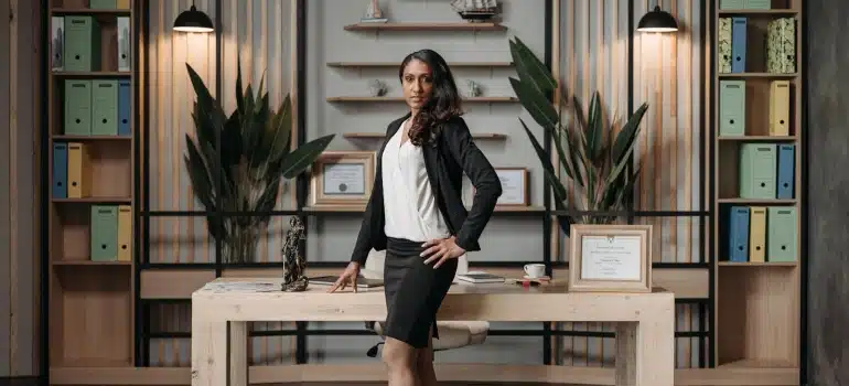 a woman standing in front of office shelves
