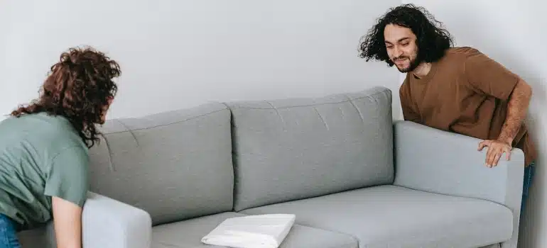 people lifting a sofa
