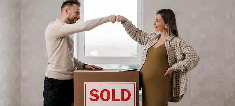 a couple pumping fists before moving while pregnant 