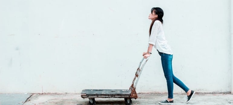 a woman using a dolly